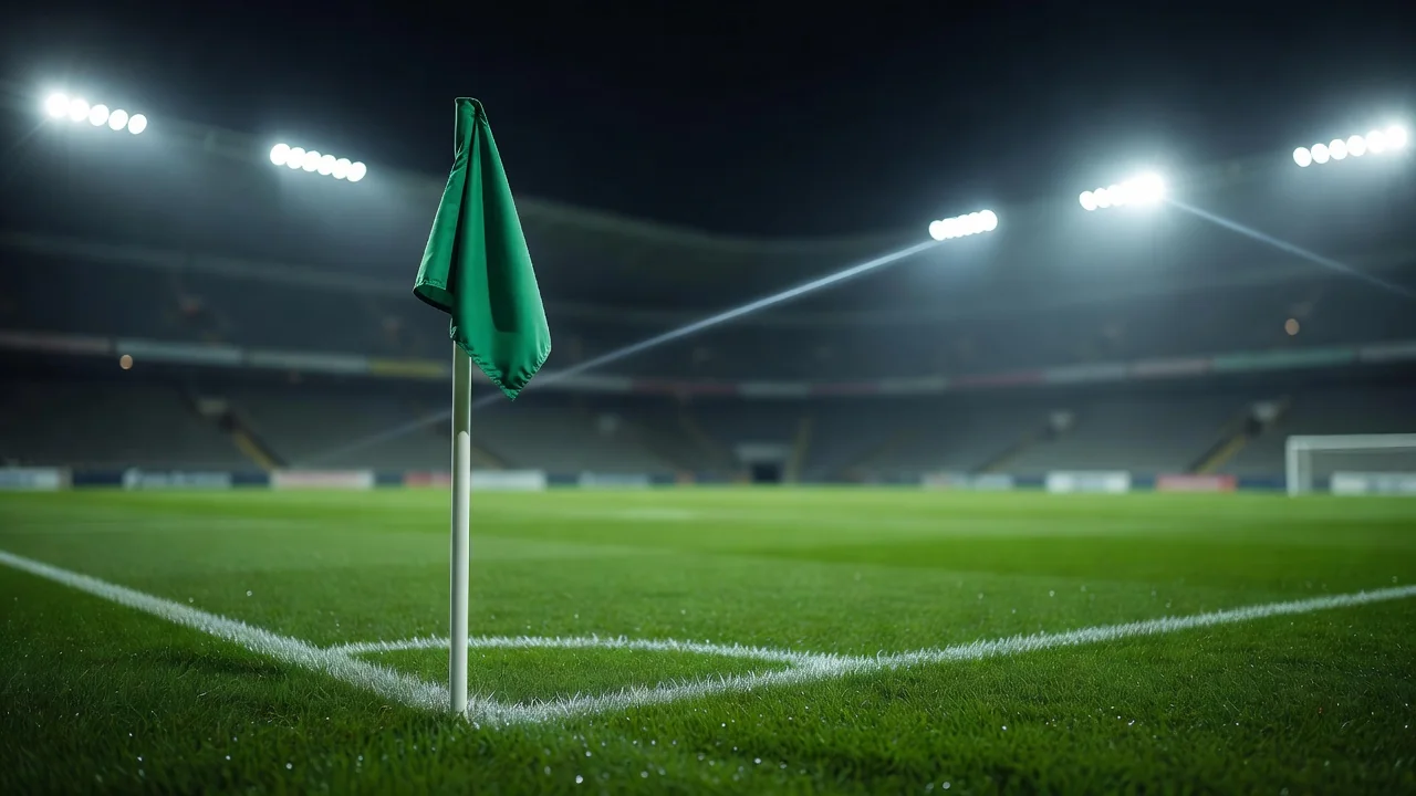 Corner flag at night with floodlight flare and blurred empty stands
